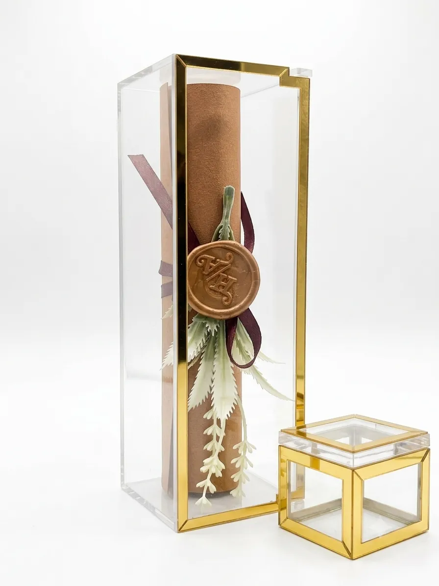Scroll wedding invitation card close-up with ribbon and gold foil script